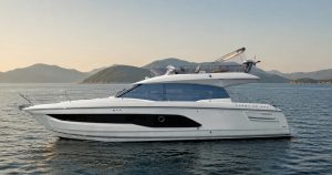 Prestige 420 flybridge motor yacht on calm water off Hong Kong's coast, illustrating a buyer-side cost of ownership analysis